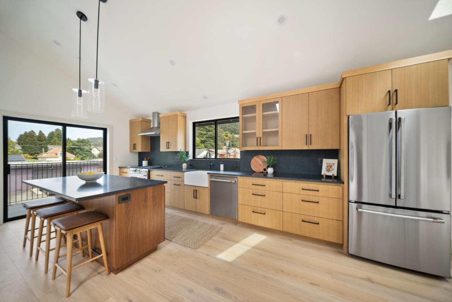 3240 North Main Street Soquel, CA 95073 - Photo 45 of 52 a kitchen with stainless steel appliances kitchen island granite countertop a refrigerator a stove and white cabinets with wooden floor