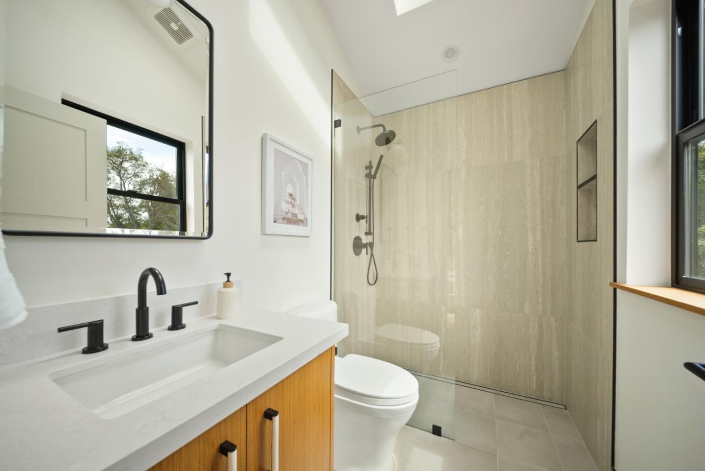 3240 North Main Street Soquel, CA 95073 - Photo 49 of 52 a bathroom with a sink a toilet a shower and a mirror