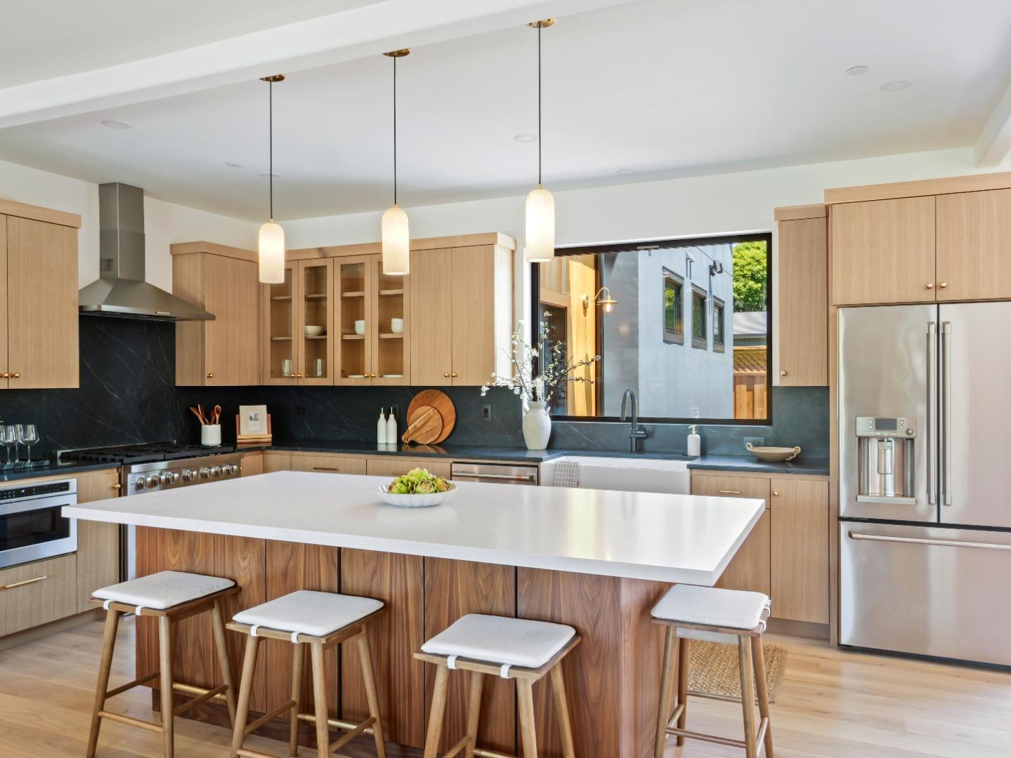 3240 North Main Street Soquel, CA 95073 - Photo 8 of 52 a kitchen with stainless steel appliances a dining table chairs and a refrigerator