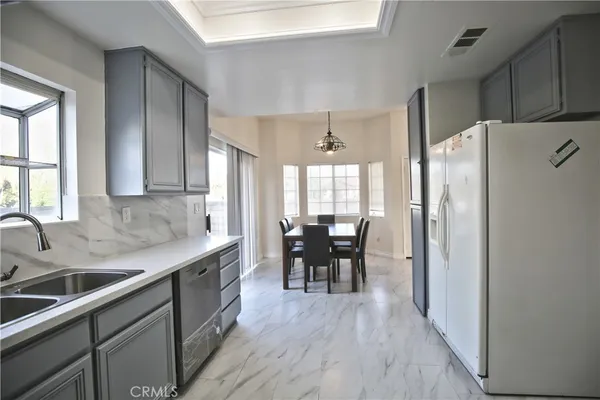 a kitchen with granite countertop appliances cabinets and wooden floor