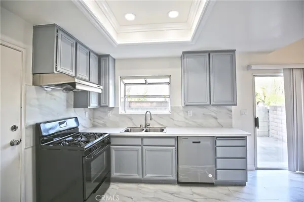 a kitchen with a sink stove and cabinets