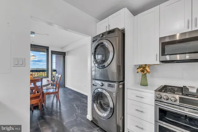 a utility room with sink dryer and washer