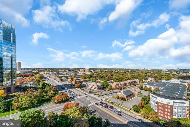 an aerial view of residential building with green space
