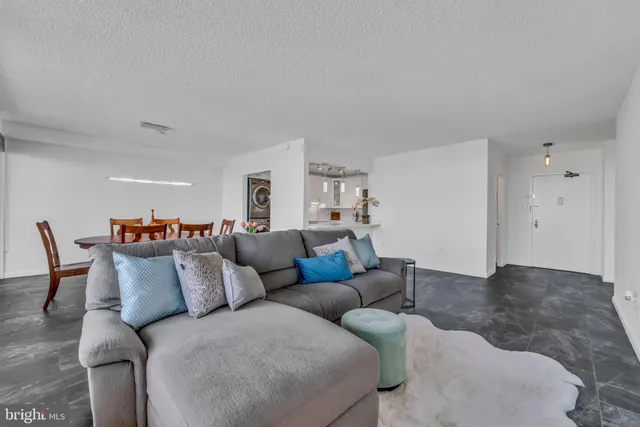 a living room with furniture and a lamp