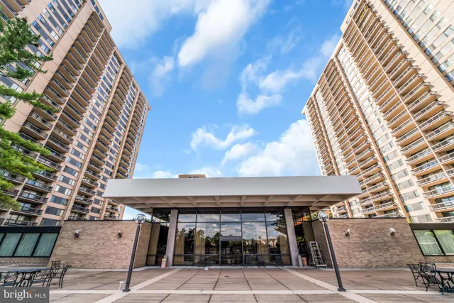a dinning table in a patio with a barbeque grill and plants