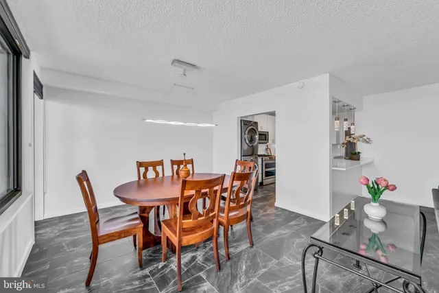 a dining room with furniture and wooden floor