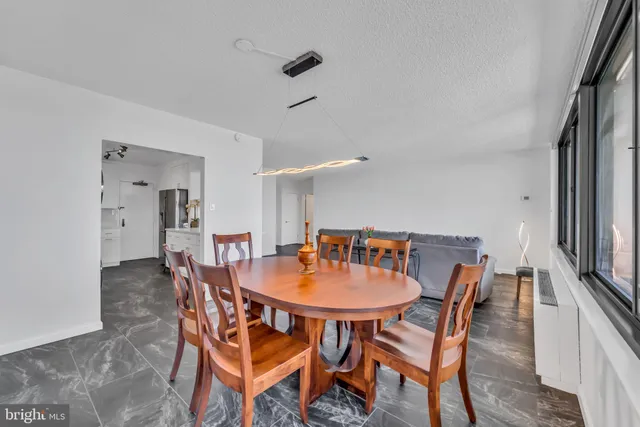 a dining room with furniture and wooden floor
