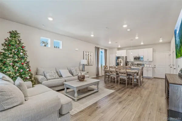 a living room with furniture wooden floor and a potted plant