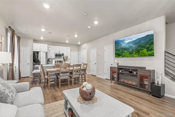a living room with furniture a flat screen tv and a fireplace
