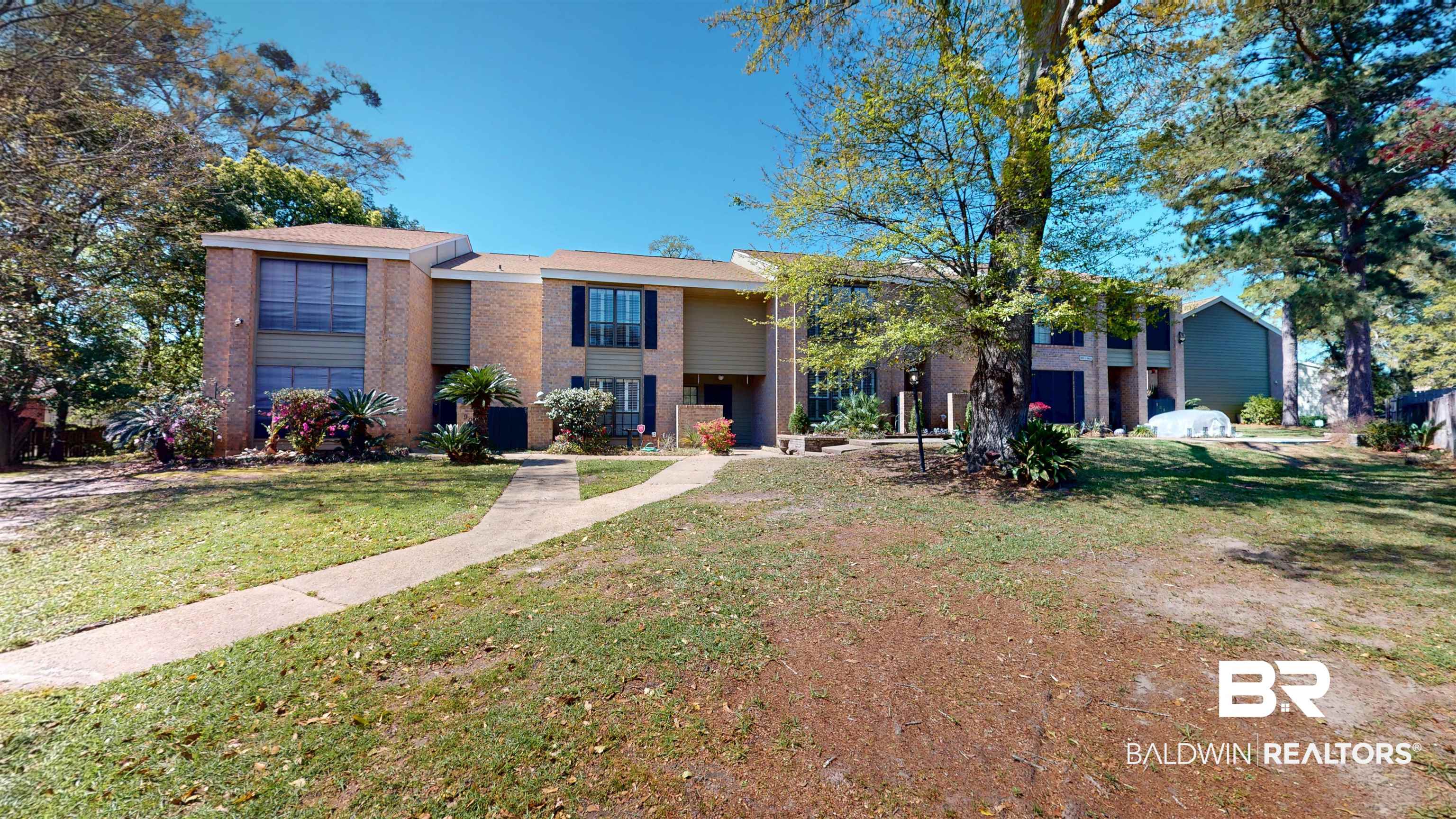 2901 Grant Street, Unit 902 Mobile, AL 36606 - Photo 24 of 35 View of front of property with a front yard and brick siding