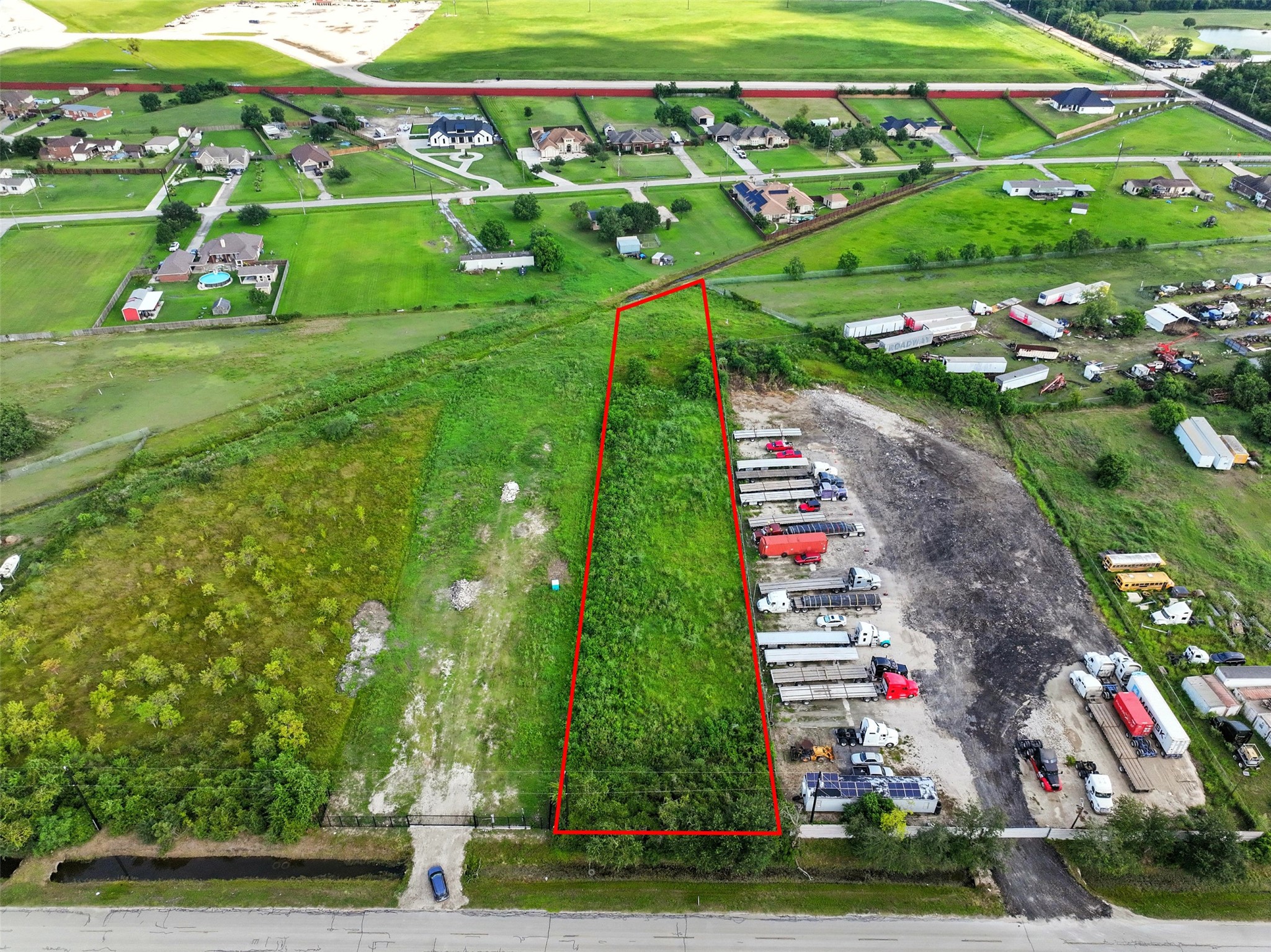 a green field with lots of trees