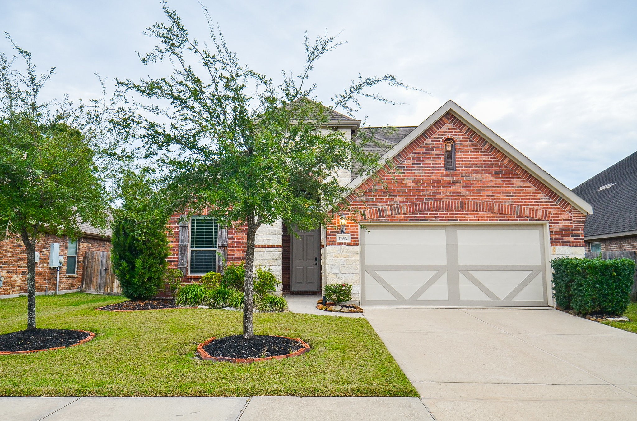 17902 Logans Pine Drive Tomball, TX 77377 - Photo 2 of 32 a front view of a house with a yard and garage