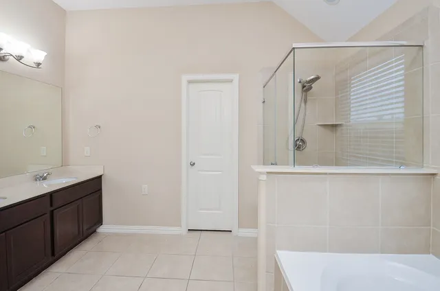 a bathroom with a double vanity sink and a mirror