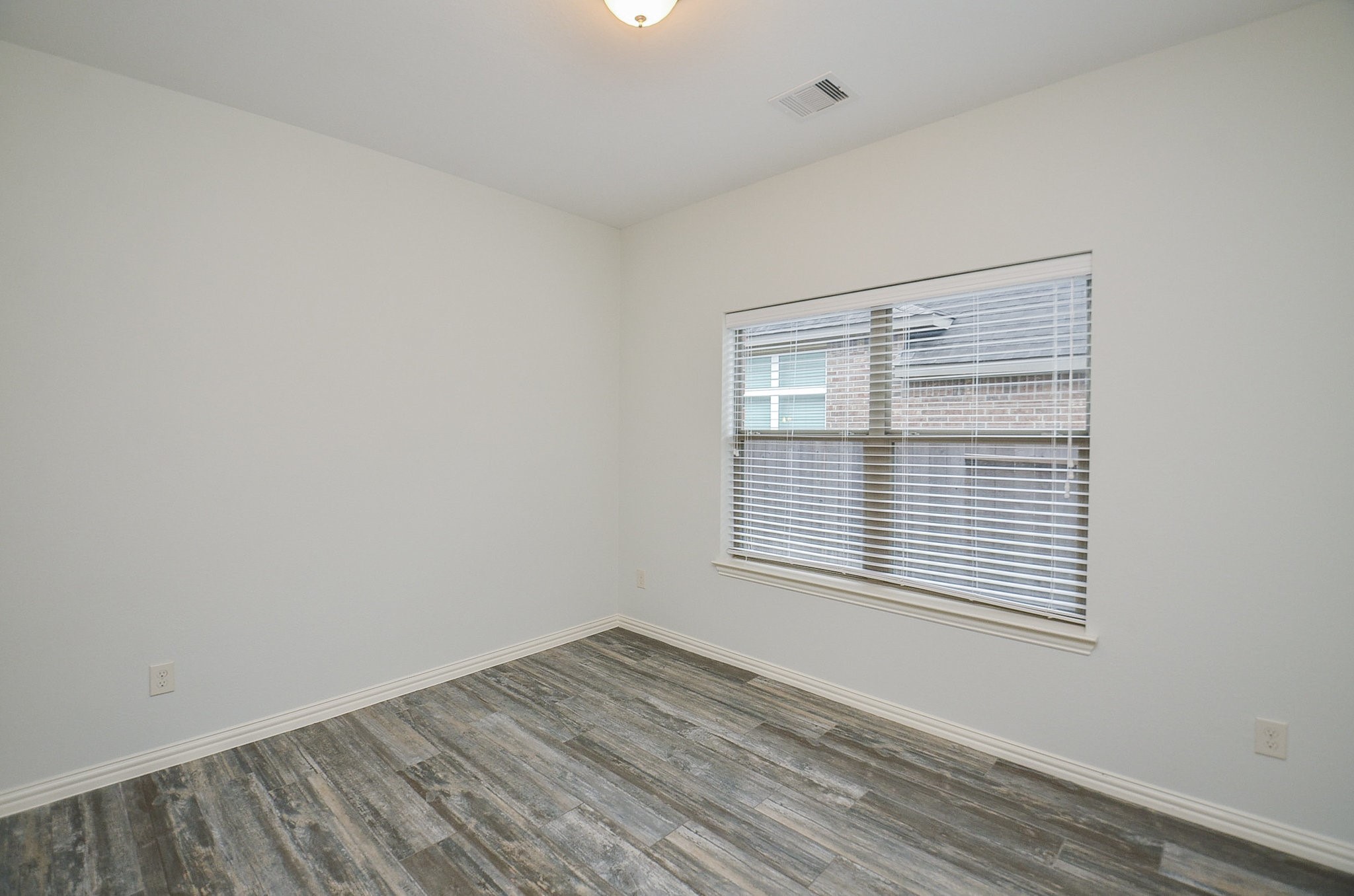 17902 Logans Pine Drive Tomball, TX 77377 - Photo 29 of 32 a view of an empty room with wooden floor and a window