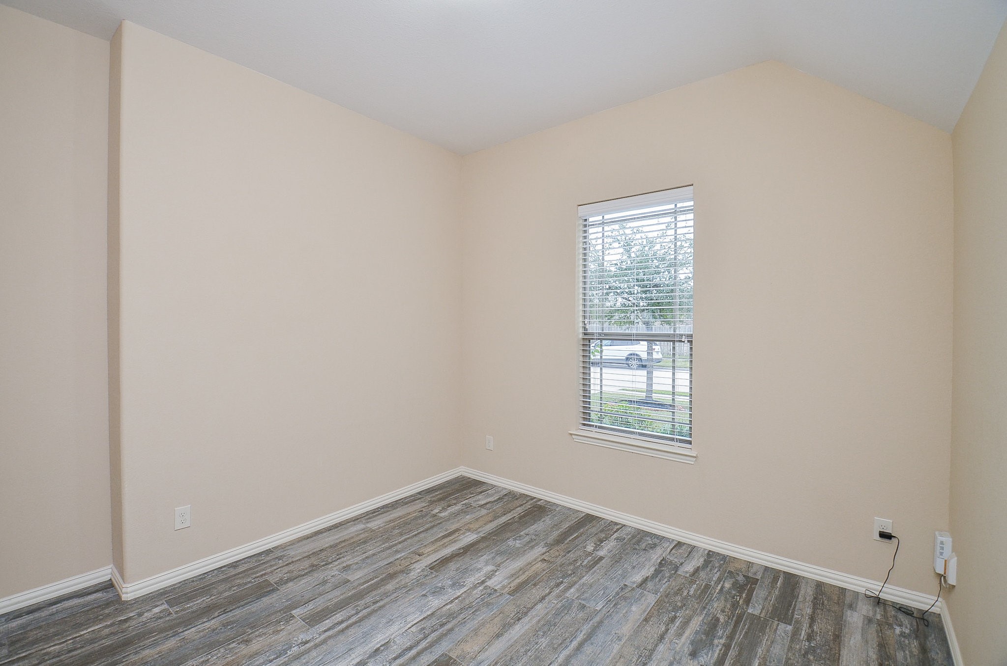 17902 Logans Pine Drive Tomball, TX 77377 - Photo 7 of 32 an empty room with wooden floor and windows