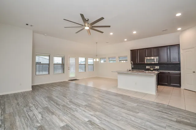 a view of kitchen with cabinets and wooden floor