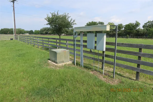 a view of a park with a big yard and potted plants