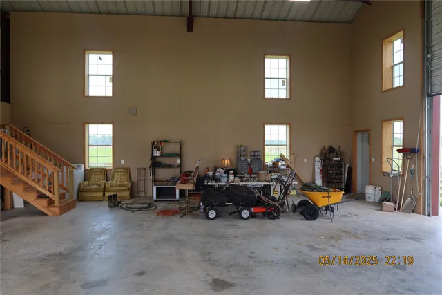 a living room with furniture and floor to ceiling windows