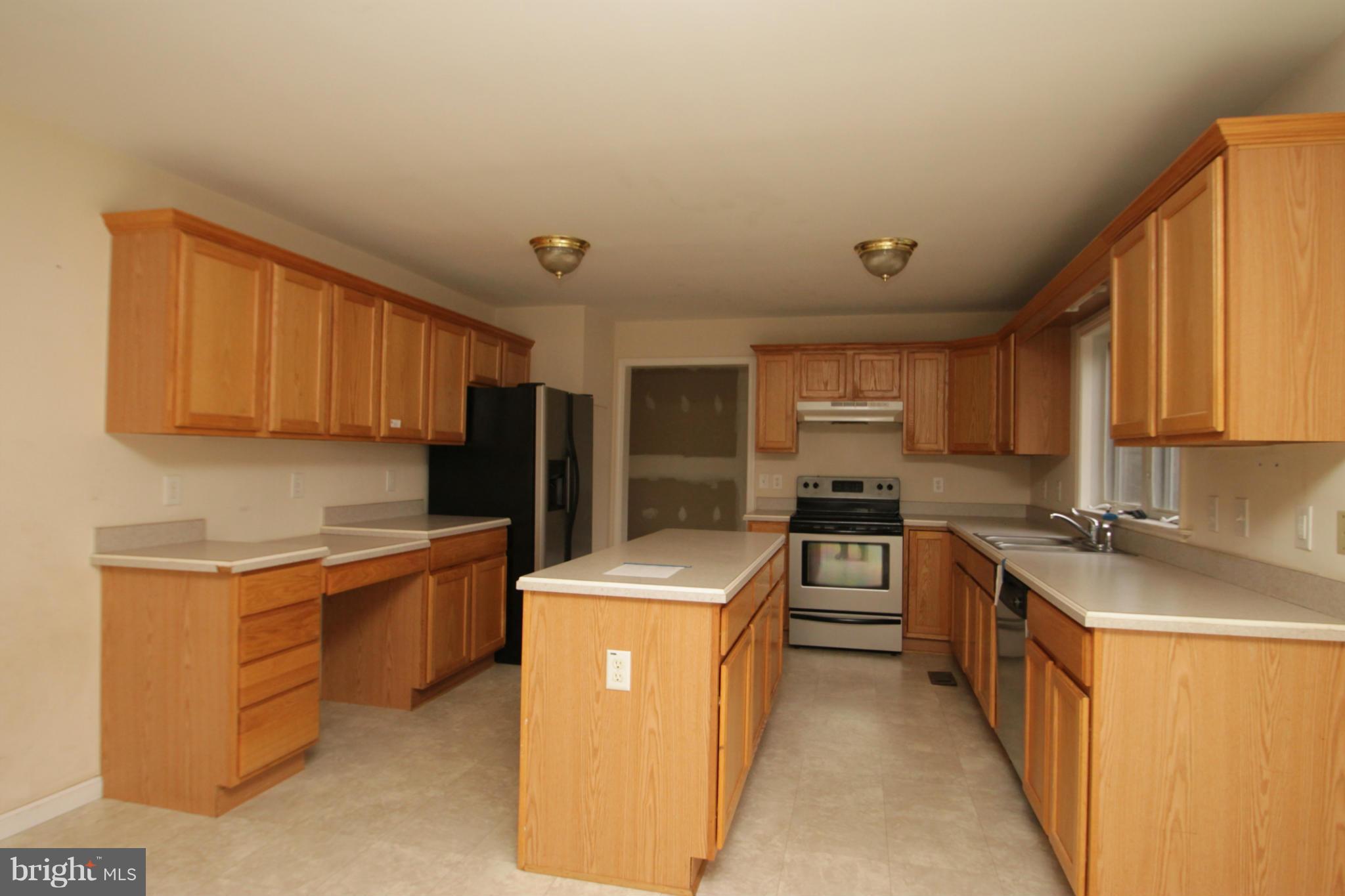 2324 Partlow Road Beaverdam, VA 23015 - Photo 14 of 27 a kitchen with stainless steel appliances granite countertop a sink stove and refrigerator