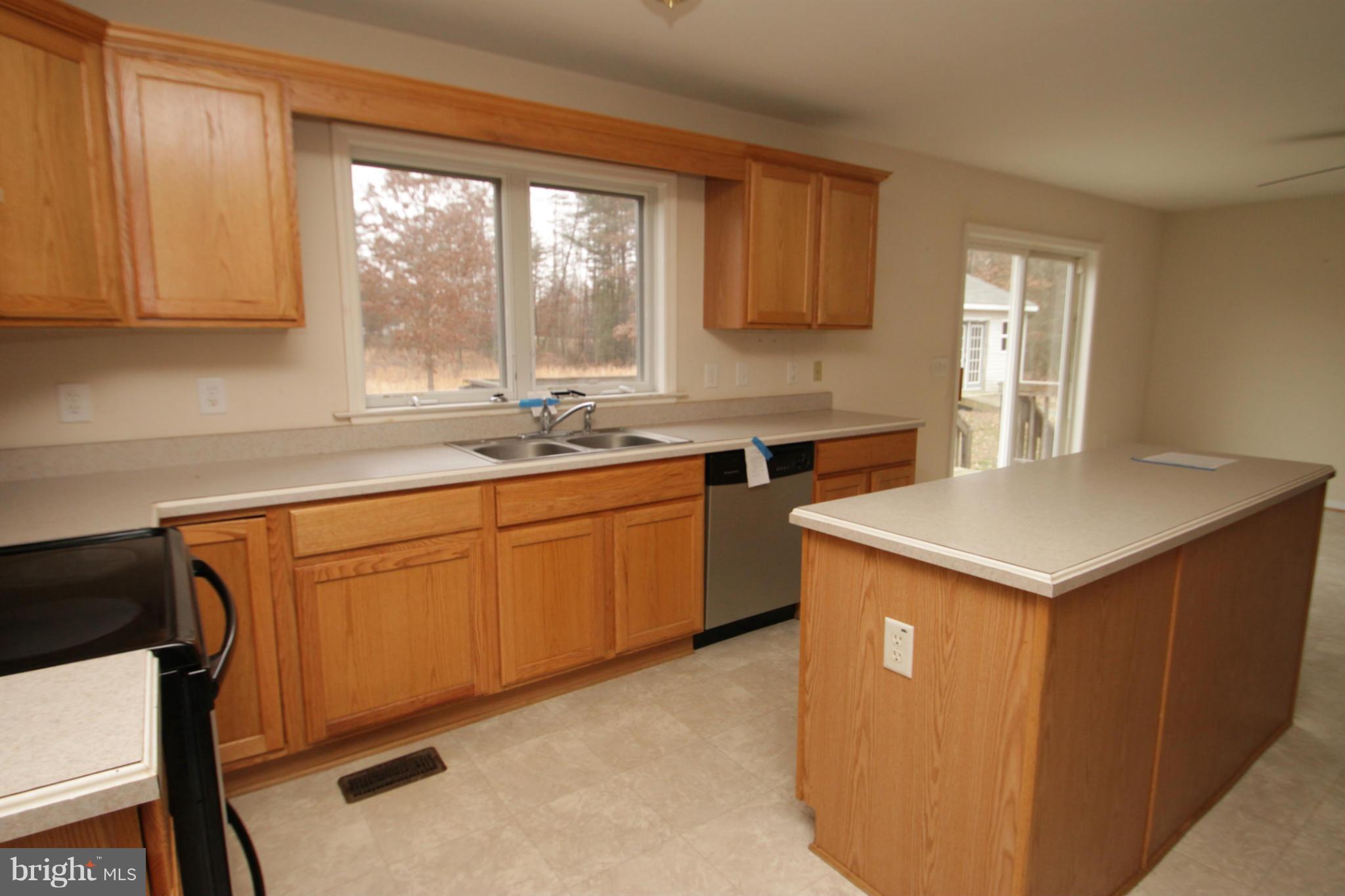 2324 Partlow Road Beaverdam, VA 23015 - Photo 15 of 27 a kitchen with a sink stove and cabinets