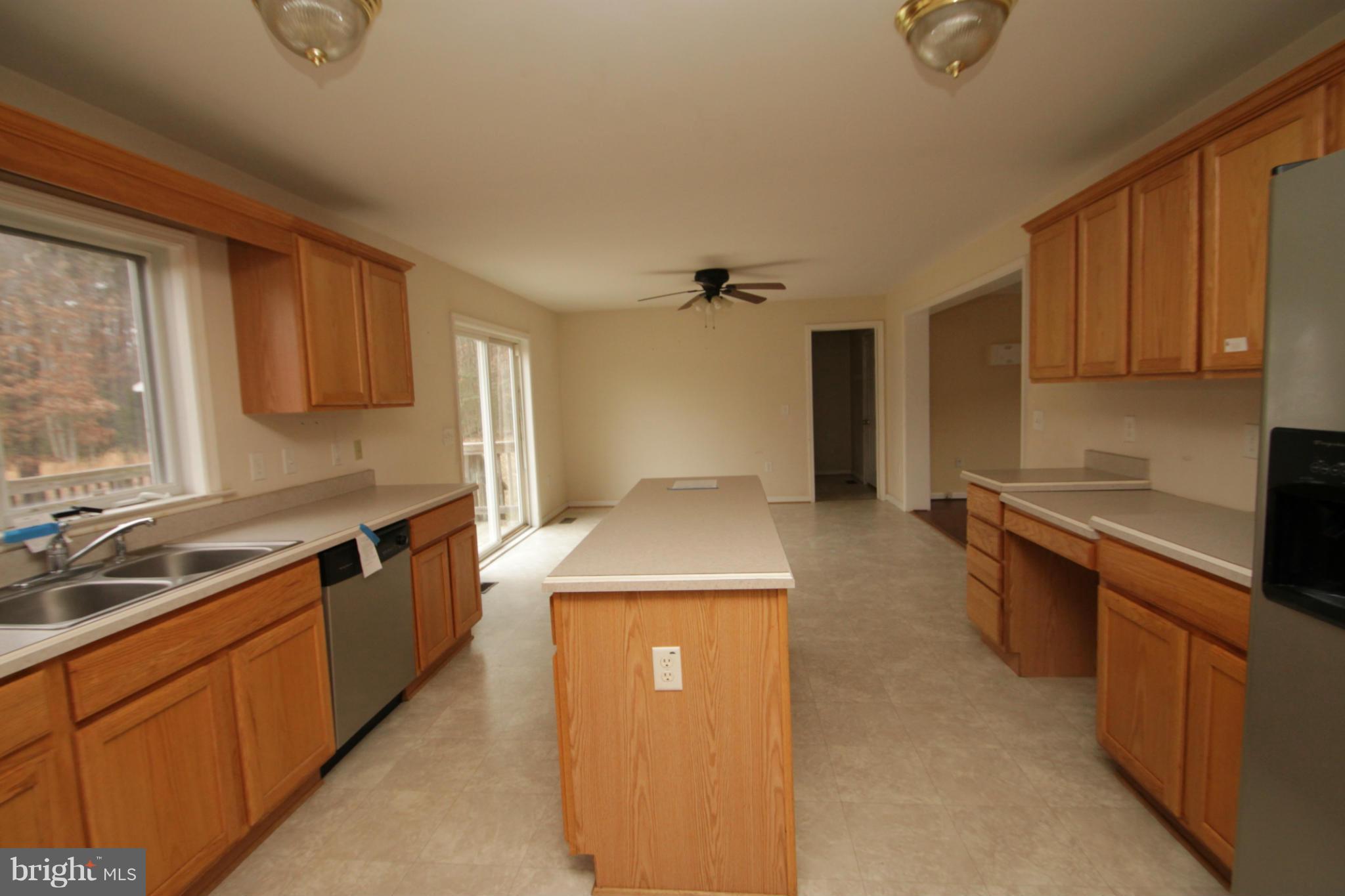 2324 Partlow Road Beaverdam, VA 23015 - Photo 16 of 27 a kitchen with a sink stove and cabinets