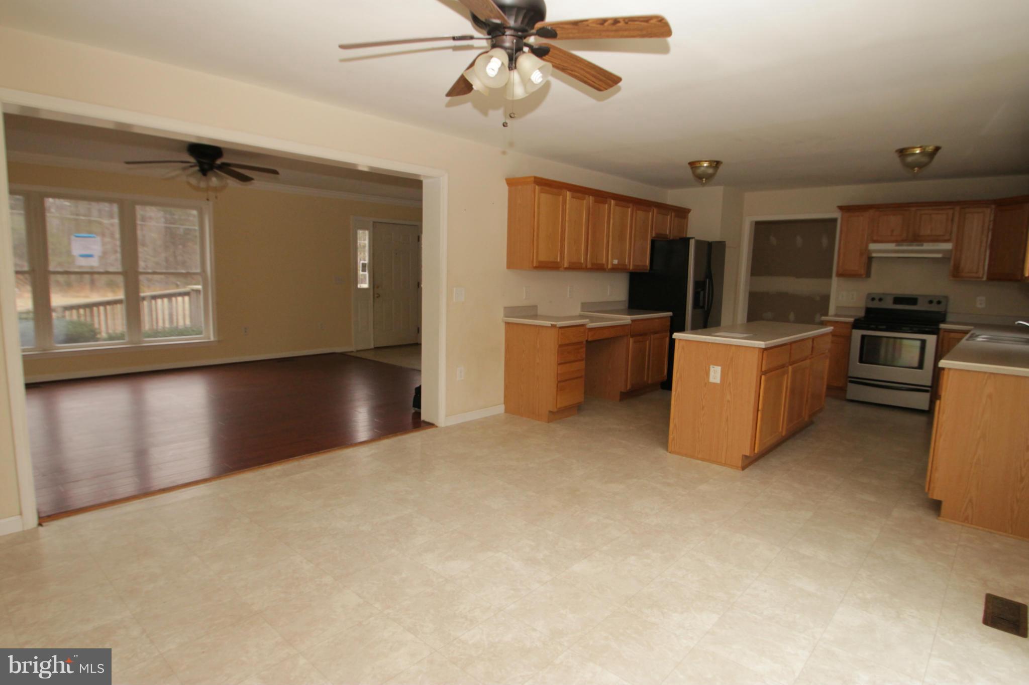 2324 Partlow Road Beaverdam, VA 23015 - Photo 18 of 27 a view of a kitchen with a stove cabinets and a ceiling fan