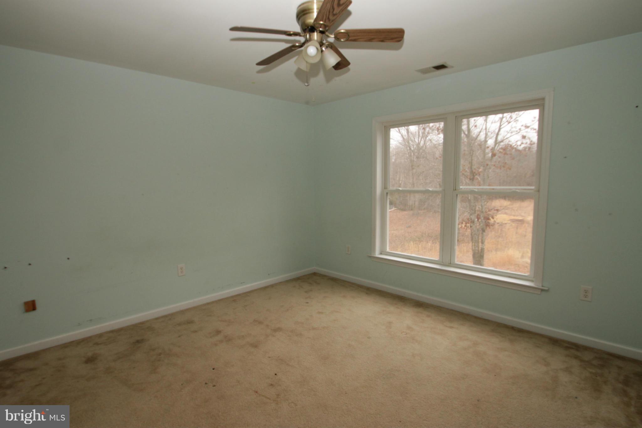 2324 Partlow Road Beaverdam, VA 23015 - Photo 25 of 27 an empty room with a window and a fan