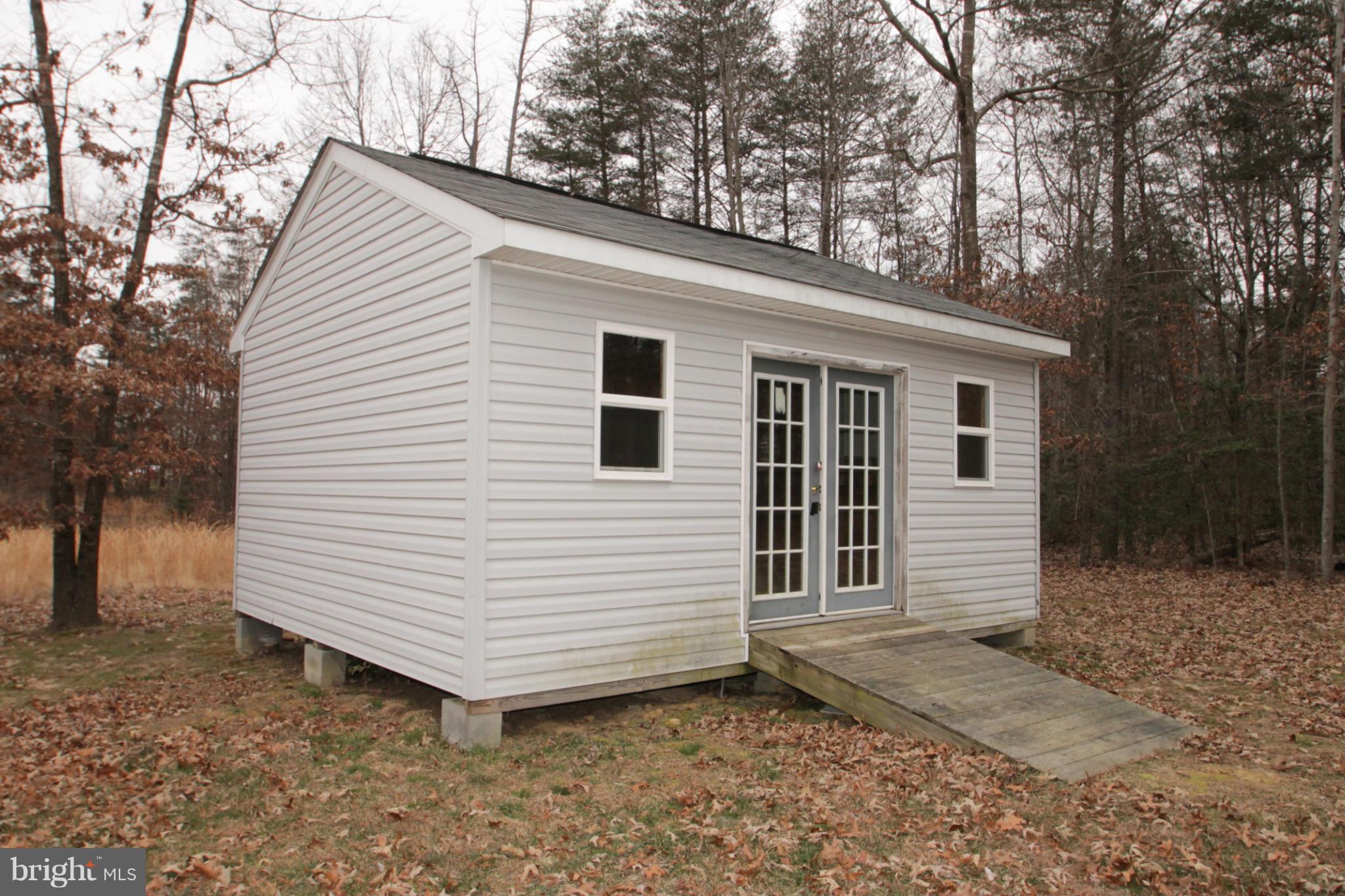 2324 Partlow Road Beaverdam, VA 23015 - Photo 6 of 27 a view of a house with a yard and garage