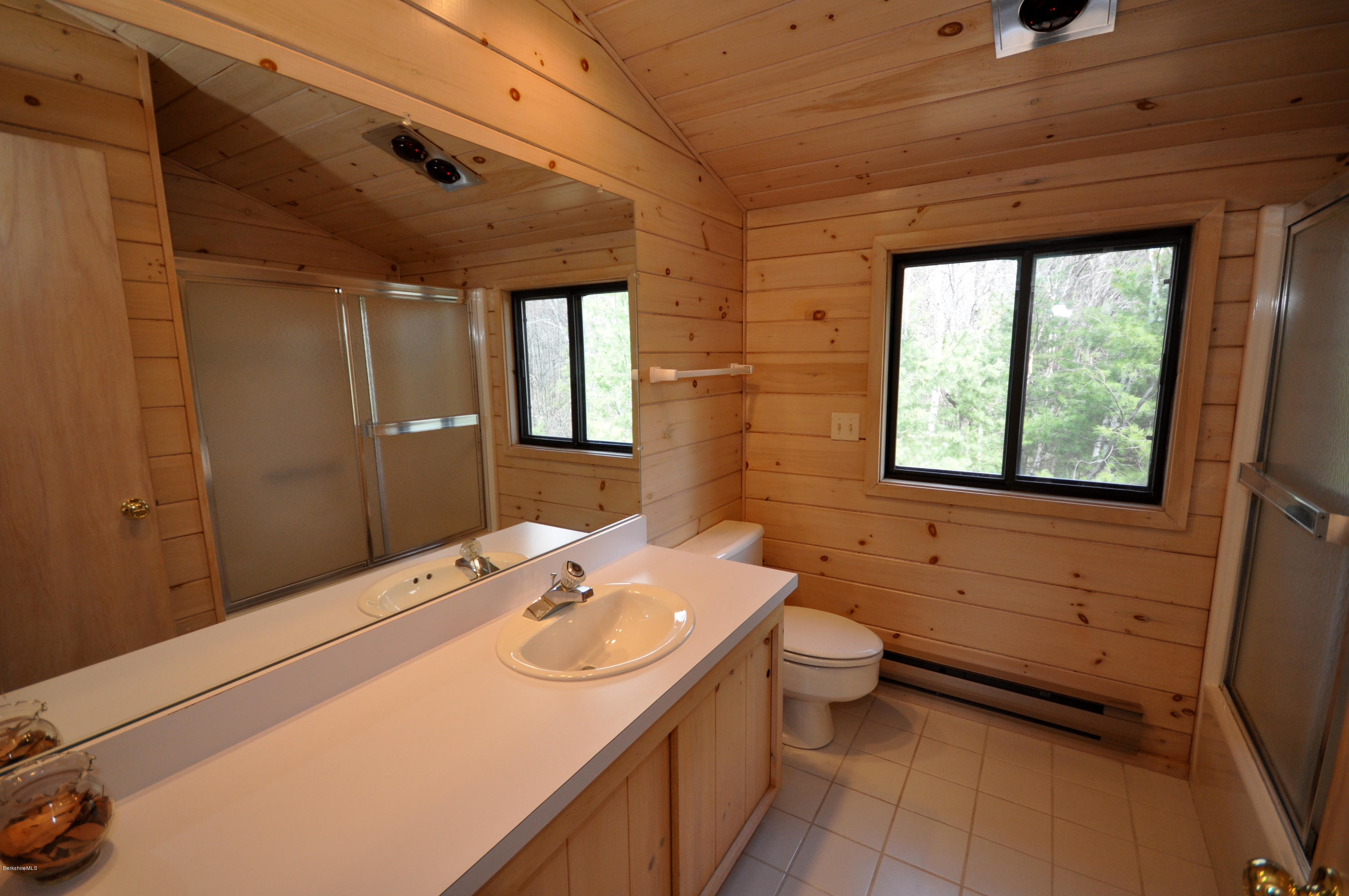 62 Algerie Road Becket, MA 01223 - Photo 22 of 29 a bathroom with a sink and a large mirror
