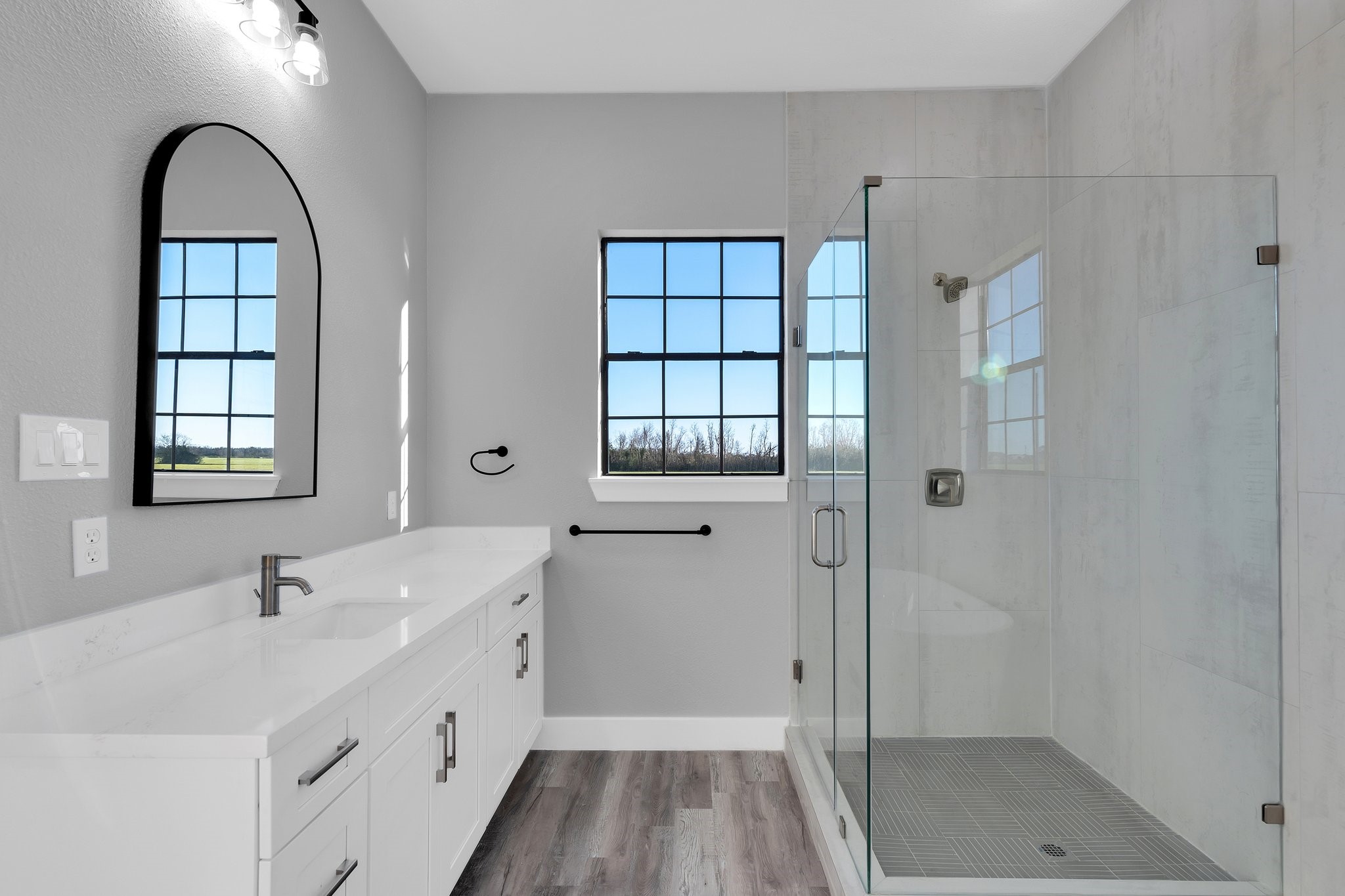 519 Chuckwagon Trail Angleton, TX 77515 - Photo 19 of 34 a bathroom with a double vanity sink a mirror and a shower