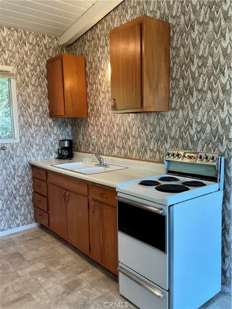a kitchen with stainless steel appliances a sink stove and cabinets