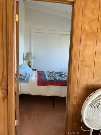 a view of bedroom with furniture and wooden floor