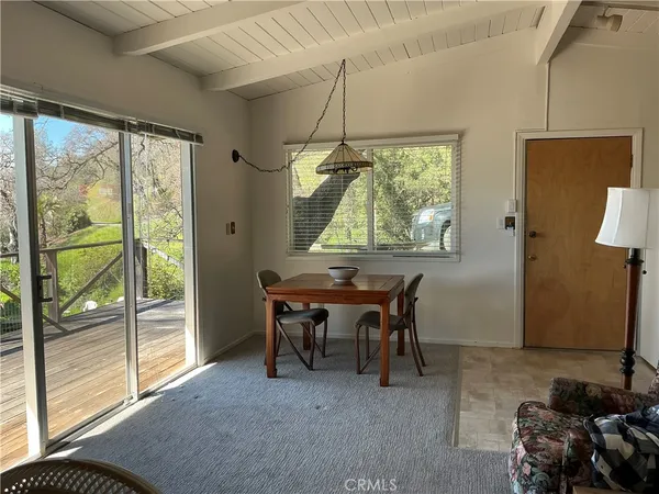 a dining room with furniture and a window