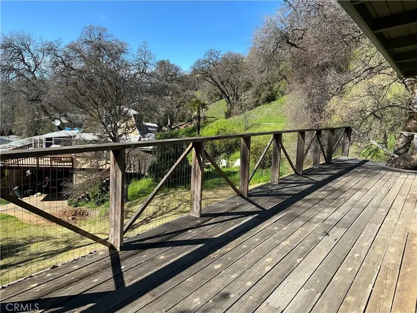 a view of balcony with wooden floor and fence