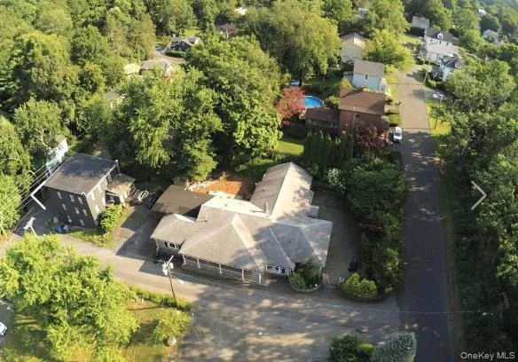 an aerial view of a house with a yard and trees