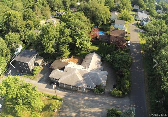 an aerial view of a house with a yard and trees