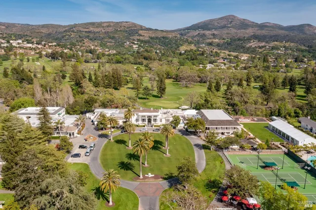 a view of a chairs and table in the backyard