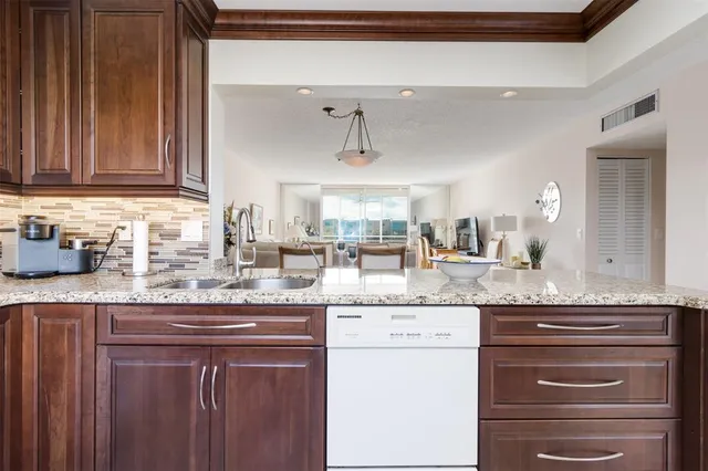 a kitchen with granite countertop stainless steel appliances and cabinets