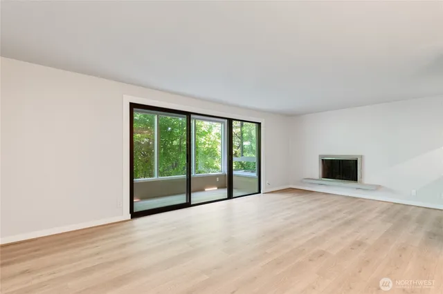 a view of an empty room with glass door