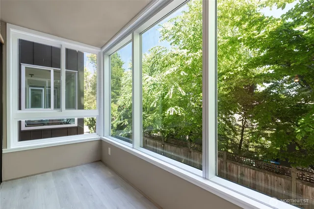 a view of room with a large window and tree