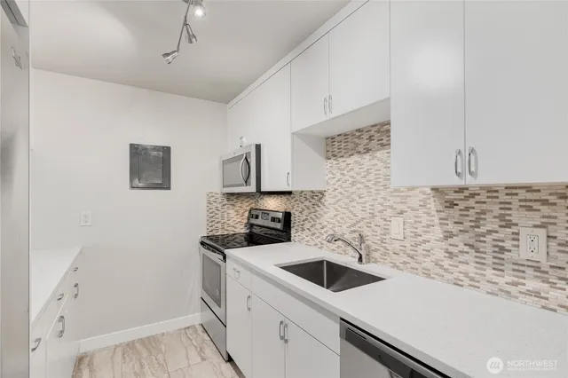 a kitchen with a sink and cabinets