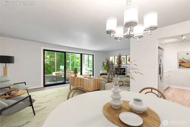 a dining room with wooden floor a chandelier fan a glass table and chairs