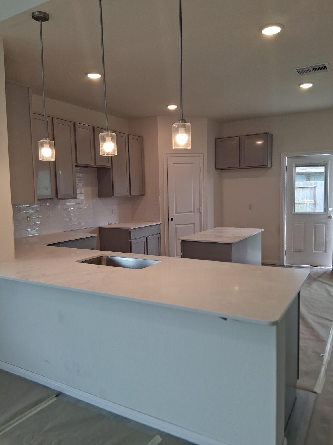 3603 Crosspointe Pass Angleton, TX 77515 - Photo 6 of 13 a large kitchen with stainless steel appliances a large counter top a refrigerator a sink and a fireplace