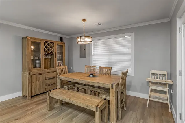 a view of a dining room with furniture and wooden floor