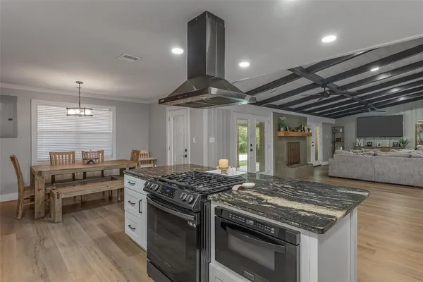 a kitchen with granite countertop white cabinets and white appliances