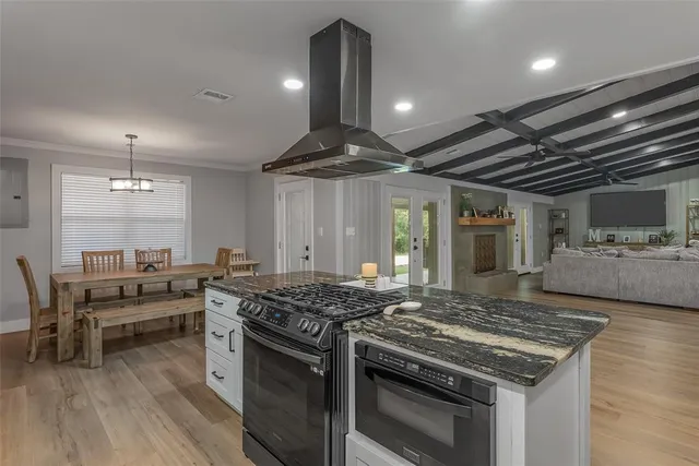 a kitchen with granite countertop white cabinets and white appliances