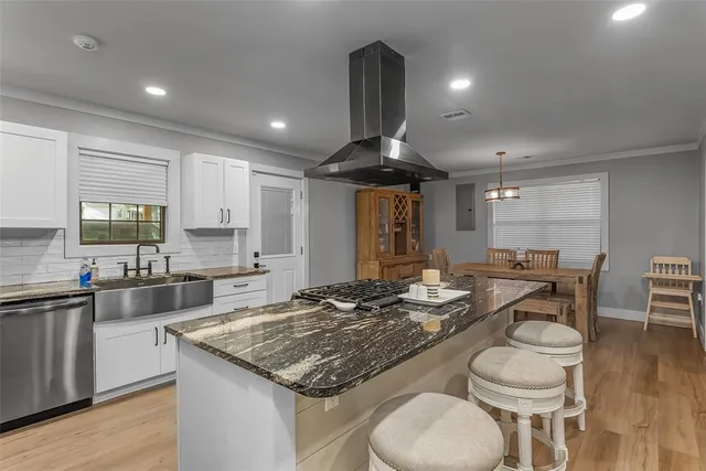 a kitchen with a stove and a kitchen island