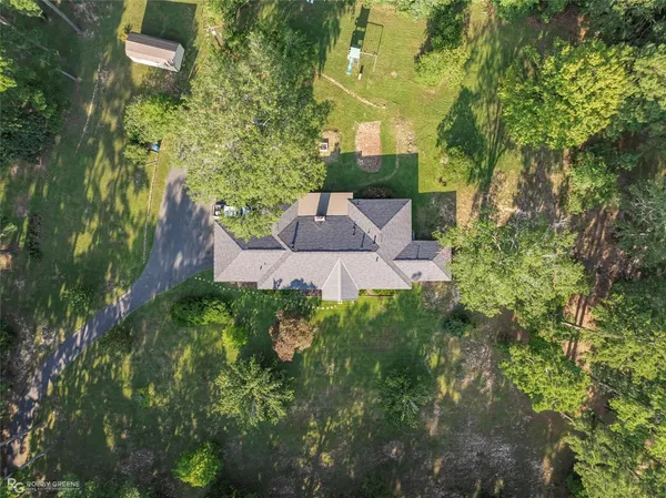 an aerial view of a house with a yard and garden