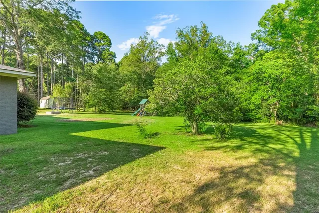 a view of a swimming pool with a yard