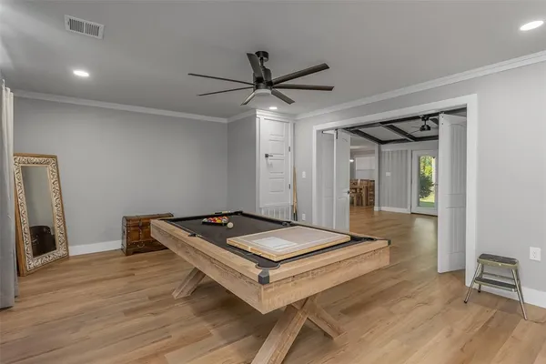 a living room with hard wood floors and a table